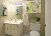 Thumbnail 24 of 27 - Half Bath with white cabinets and tiled floor at Alpine Village Apartments in La Vista, Nebraska