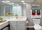 Thumbnail 36 of 36 - Luxury apartments with wood grain plank floors, extra cabinet space, white cabinets, built-in vanity, oval soaking tub, and glass shower at Lenox Village Apartments in Lincoln, NE