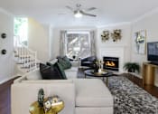 Thumbnail 16 of 26 - Spacious living room with wood-burning fireplace, wood plank flooring, huge living room at Tuscany Villas Townhomes in Houston.