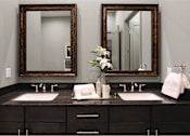 Thumbnail 53 of 62 - Double vanity bathroom with two mirrors and a black granite vanity top