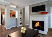 Thumbnail 11 of 36 - Luxury apartments with wood grain plank floors, built-in shelves, dining room, u-shaped kitchen, 9-foot ceilings, and woodburning fireplace at Lenox Village Apartments in Lincoln, Nebraska
