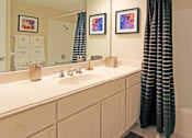 Thumbnail 30 of 41 - Bathroom with white cabinets, lots of cabinet space, soaking tub, and tiled floor at Embassy Park Apartments in Omaha, Nebraska