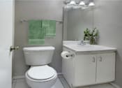 Thumbnail 19 of 20 - Half bath with white cabinets, tiled floor, and gray wall color at Inwood Apartments in La Vista, Nebraska