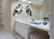 Thumbnail 9 of 38 - Luxury bathroom with tiled floors, oval soaking tub, built-in vanity, cultured marble vanity, glass shower and white cabinets in at TurtleCreek apartments in West Des Moines, Iowa