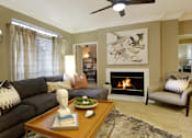 Thumbnail 12 of 22 - a living room with a couch and a fireplace