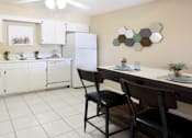 Thumbnail 14 of 27 - Spacious kitchen with lots of cabinet space, lots of counter space, white kitchen cabinets, bright white kitchen, porcelain tile floor, huge kitchen at Alpine Village Apartments in La Vista, Nebraska