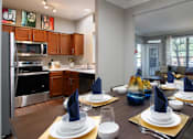 Thumbnail 27 of 36 - Luxury apartments with wood grain plank floors, dining room, u-shaped kitchen, 9-foot ceilings, gray colored walls, and built-in shelves, at Lenox Village Apartments in Lincoln, Nebraska