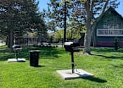 Thumbnail 18 of 27 - Apartments with grilling station, picnic area, park-like setting with lots of trees, beautiful landscaping, lush landscaping, and scenic views at Alpine Village Apartments in La Vista, Nebraska
