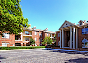 Thumbnail 6 of 22 - Gated apartment community near the Galleria in Dallas with luxury clubhouse and resident lounge, free wi-fi, meeting room, red brick exteriors, and beautiful landscaping at The Dorchester Apartments