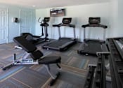 Thumbnail 23 of 27 - Remodeled fitness center, 24-hour fitness center at Alpine Village Apartments in La Vista, Nebraska
