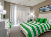 Thumbnail 39 of 42 - Spacious bedroom with walk-in closet and gray painted walls at Woodlake on the Bayou Apartments