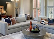 Thumbnail 26 of 36 - a living room with couches and a coffee table
