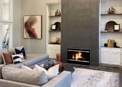 Thumbnail 6 of 36 - a living room with a fireplace and a couch