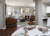 Thumbnail 1 of 38 - Luxury apartments with plank wood floors, woodburning fireplace, French door, white cabinets, stainless steel appliances, and granite countertops at TurtleCreek apartments in West Des Moines, Iowa