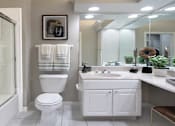 Thumbnail 37 of 38 - Luxury bathroom with tiled floors, oval soaking tub, built-in vanity, cultured marble vanity, glass shower and white cabinets in at TurtleCreek apartments in West Des Moines, Iowa