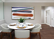 Thumbnail 17 of 38 - Spacious dining room with mirror accent wall and plank wood floors at TurtleCreek apartments in West Des Moines, Iowa