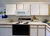Thumbnail 18 of 44 - Spacious kitchen with extra cabinet space, extra counter space, tiled floors, bright white kitchen, at Tanglewood Apartments in Lincoln, Nebraska
