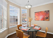 Thumbnail 9 of 25 - Spacious dining room with large bay windows and hardwood floors at Tuscany Park Apartments in Houston.