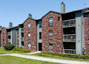 Thumbnail 10 of 35 - Green and red brick exterior, beautiful landscaping, scenic views, lots of trees, and spacious balconies at LionsHead Apartments in Omaha, Nebraska