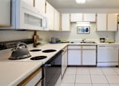 Thumbnail 3 of 44 - Spacious kitchen with extra cabinet space, extra counter space, tiled floors, bright white kitchen, at Tanglewood Apartments in Lincoln, Nebraska