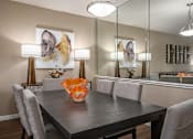 Thumbnail 6 of 42 - Dining area with mirror accent wall at Woodlake on the Bayou Apartments in Houston Texas