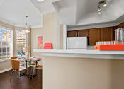 Thumbnail 22 of 25 - Spacious dining room with large bay windows and wood plank floors at Tuscany Park Apartments in Houston.