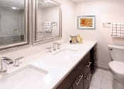 Thumbnail 27 of 43 - a bathroom with a sink toilet and a mirror