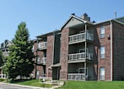Thumbnail 5 of 27 - Apartments with brick exteriors, beautiful landscaping, lush landscaping, scenic views, large balconies, spacious balconies, at Alpine Village Apartments in La Vista, Nebraska