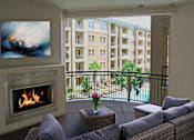 Thumbnail 11 of 42 - Large spacious balcony with patio fireplace and pool view at Tuscany Walk Apartments in Houston Texas.