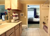 Thumbnail 27 of 36 - Luxury apartments with spacious bathrooms with tiled floors, extra storage and cabinet space, oval soaking tubs, granite countertops, and washed oak cabinets in north Dallas at Kensington Square Apartments.