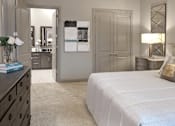 Thumbnail 17 of 45 - Spacious master bedroom with attached luxury master bath suite and 11-foot ceilings and walk-in closet at Le Palais Apartments in Houston.