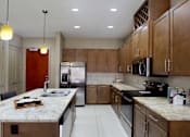 Thumbnail 42 of 46 - Luxury apartments with spacious open floor plan, granite countertops, stainless steel appliances, built-in wine rack, kitchen island, and porcelain tile floor at Bellemeade Apartments in west Des Moines