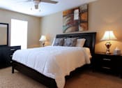 Thumbnail 5 of 21 - Spacious bedroom with ceiling fan and walk-in closet at Briarwood Apartments in Houston.