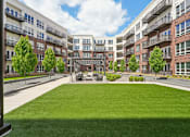 Thumbnail 58 of 62 - Luxury apartments with huge courtyard with lush landscaping, green space, outdoor seating area and pergola at Xenia Apartments in Golden Valley Minnesota