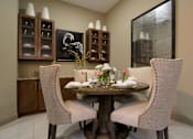 Thumbnail 15 of 42 - Luxury dining room with built-in buffet with granite slab top, and 10-foot ceilings at Tuscany Walk Apartments in Houston Texas.