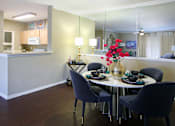 Thumbnail 11 of 36 - Luxury apartments with spacious kitchen, wood plank floors, breakfast bar, washed oak cabinets, mirror accent wall, spacious dining room, extra pantry storage, and 9-foot ceilings at Kensington Square Apartments.
