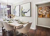 Thumbnail 10 of 73 - Spacious dining room with wood plank floors and oversized windows, luxury apartments in Dallas