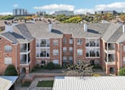 Thumbnail 66 of 73 - Gated luxury apartment community in north Dallas with red brick exteriors, covered parking, and beautiful landscaping at The Saxony Apartments