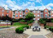 Thumbnail 36 of 38 - Luxury apartments with red brick exteriors, lush landscaping, landscaped courtyard, and beautiful grounds at TurtleCreek Apartments in West Des Moines
