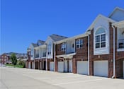 Thumbnail 22 of 31 - A row of townhouses with garages on the side.