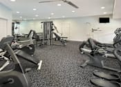 Thumbnail 9 of 35 - Fitness center with cardio and weight lifting equipment at Breckenridge Apartments in Omaha, Nebraska