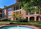 Thumbnail 39 of 73 - Gated apartment community with landscaped courtyards, beautiful landscaping, and beautiful courtyards with fountains at The Saxony Apartments in north Dallas