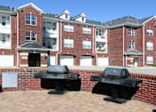 Thumbnail 10 of 31 - Luxury apartments with red brick exteriors, resident grilling station, and attached garages at Rockledge Oaks Apartments in Lincoln, Nebraska