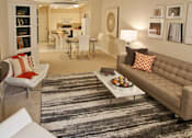 Thumbnail 14 of 41 - Spacious apartment in central Omaha with condo-style layout, white kitchen cabinets, kitchen island, and built-in shelves at Embassy Park Apartments