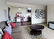 Thumbnail 19 of 27 - Spacious living room, dining room and kitchen with wood laminate flooring at Kensington Woods Apartments