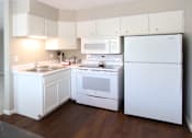 Thumbnail 10 of 27 - Apartments in central Omaha with spacious layout, spacious living room, bright white kitchen, gray wall color, and white kitchen cabinets at Kensington Woods Apartments in Omaha, Nebraska