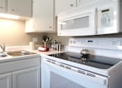 Thumbnail 18 of 27 - Kitchen with white cabinets, bright white kitchen at Kensington Woods Apartments in Omaha, Nebraska