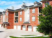 Thumbnail 12 of 36 - Luxury apartments with red brick exterior, attached garages, lush landscaping, and scenic views at Lenox Village Apartments in Lincoln, Nebraska
