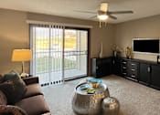 Thumbnail 20 of 35 - Spacious living room with large patio door windows at LionsHead Apartments in Omaha Nebraska