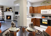 Thumbnail 5 of 36 - Luxury apartments with wood grain plank floors, dining room, u-shaped kitchen, 9-foot ceilings, and woodburning fireplace at Lenox Village Apartments in Lincoln, Nebraska